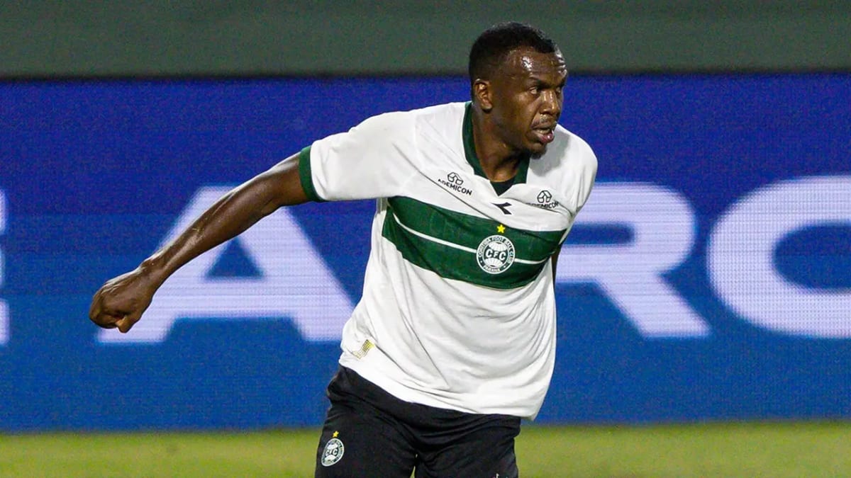 Brazilian soccer player Jacy Maranhao in red and white Coritiba uniform controlling ball during match