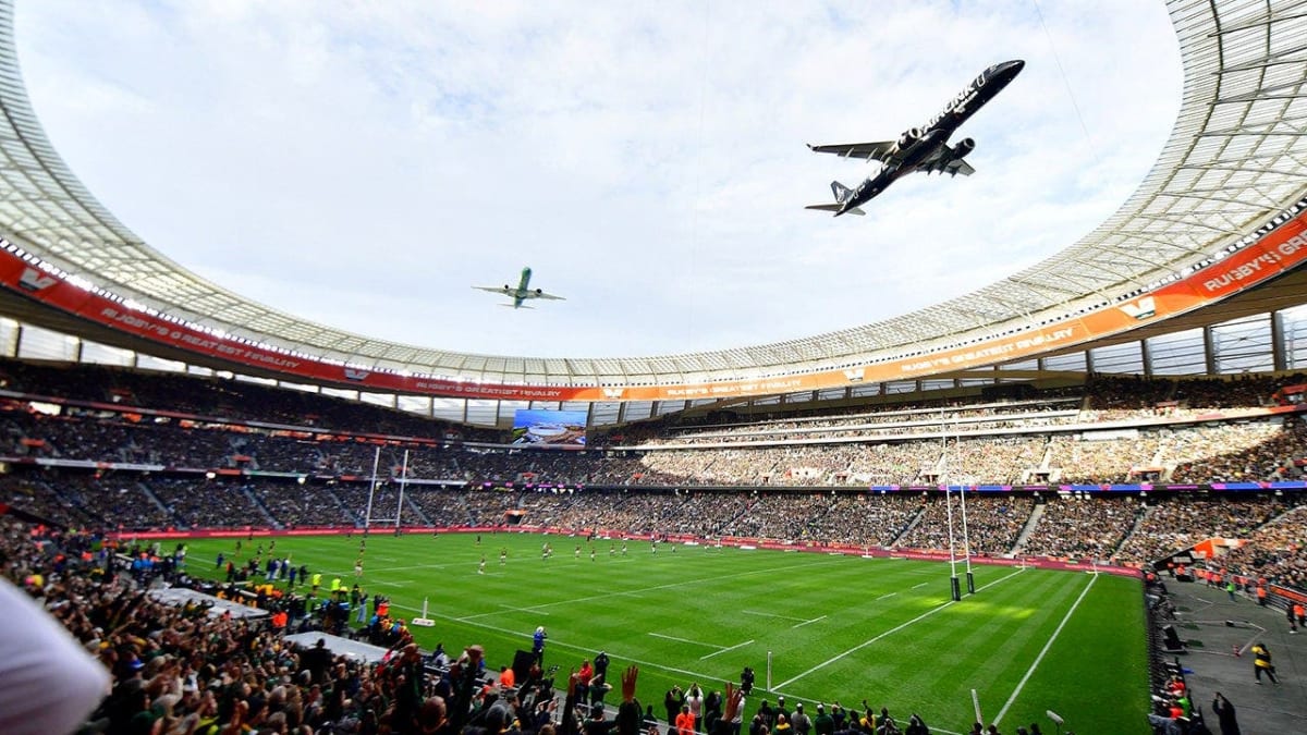 Two commercial passenger jets flying extremely low over packed rugby stadium in Cape Town
