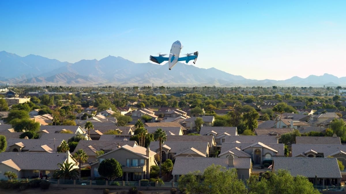 Amazon Prime Air delivery drone hovering above residential backyard preparing to lower package