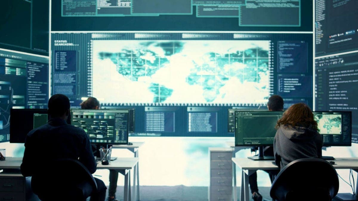 Graduate students working together on computers analyzing national security data and research
