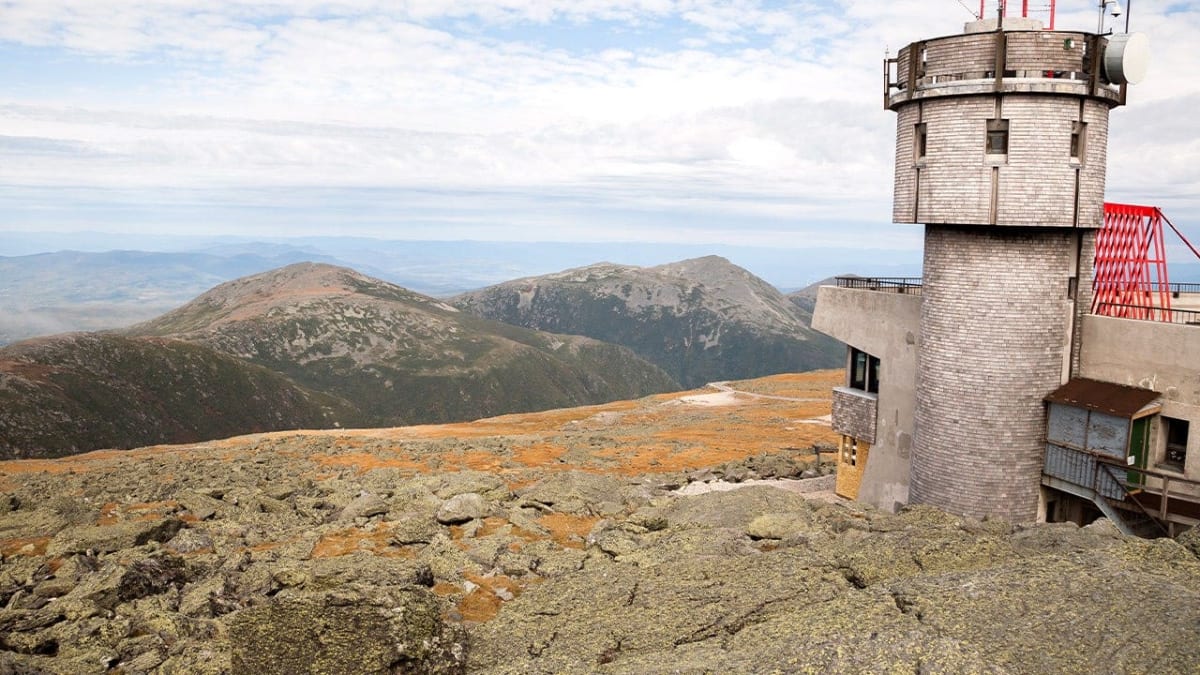 Mount Washington peak in New Hampshire with rocky granite terrain and cloudy sky