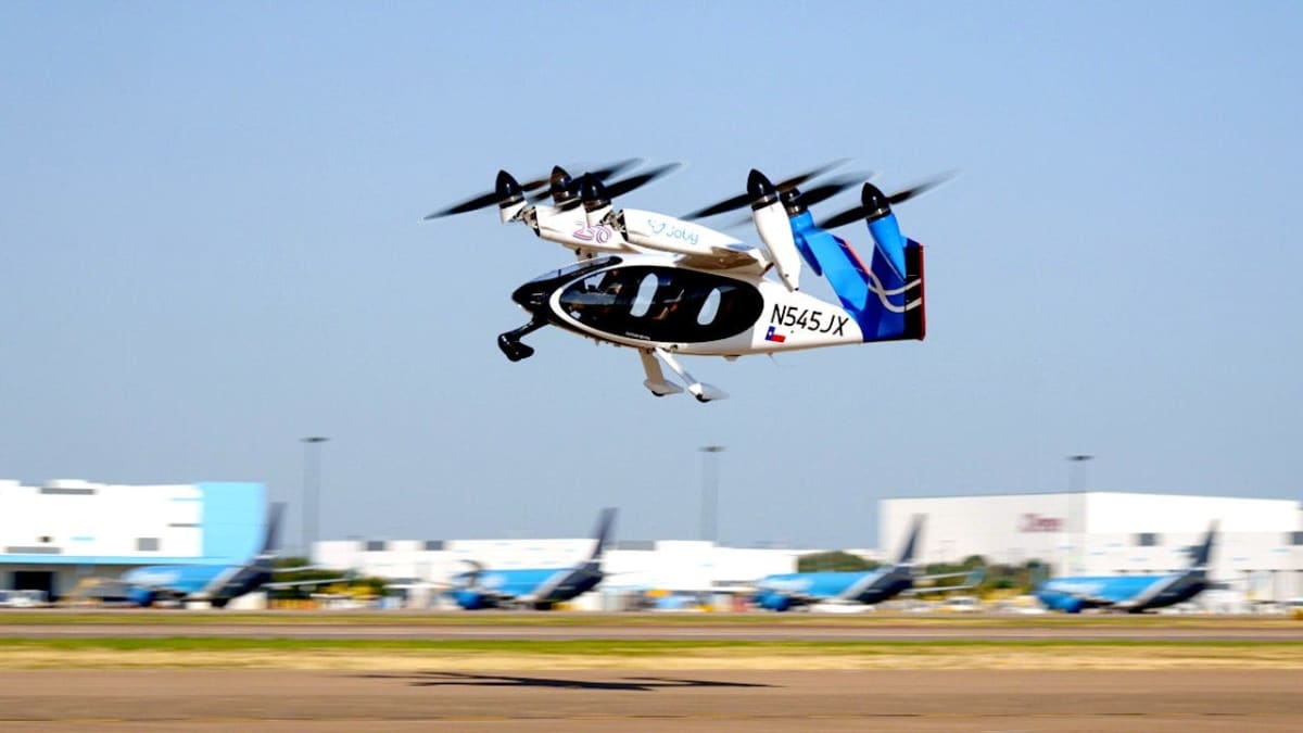 Joby Aviation's white electric air taxi aircraft with multiple rotors at Texas airport