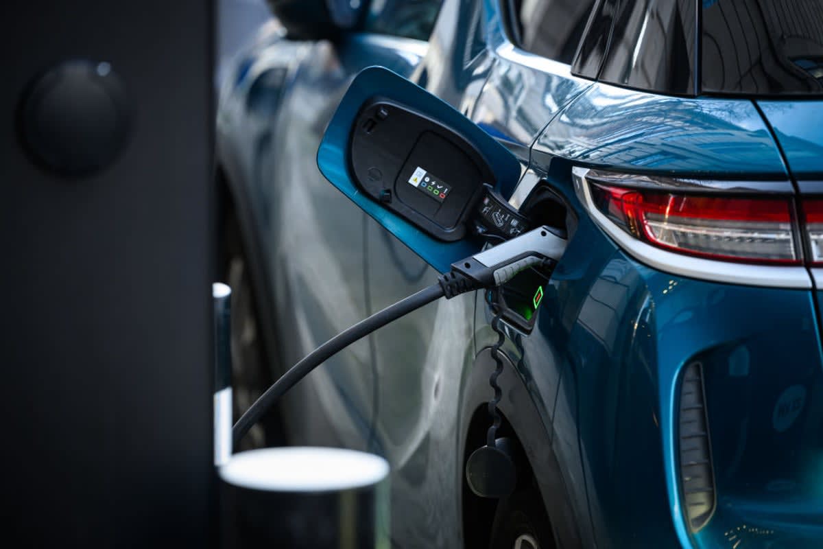 Electric vehicle charging at home station connected to smart grid energy system