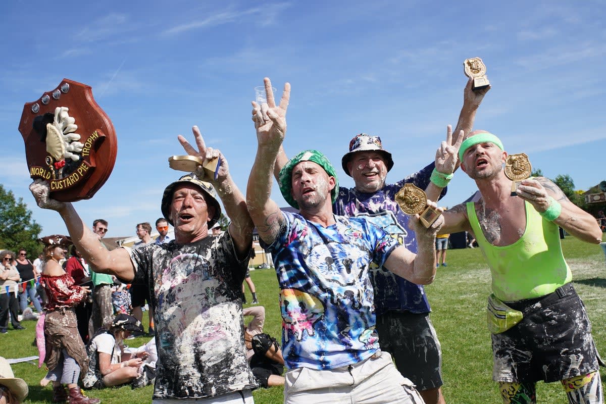 Competitors covered in custard pie mixture during the World Custard Pie Championships in Kent
