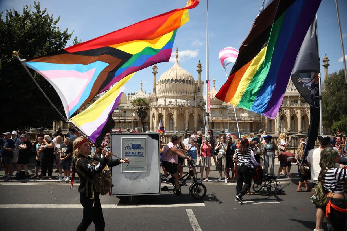 Massive crowd waves rainbow Pride flags during Brighton's 35th anniversary parade celebration
