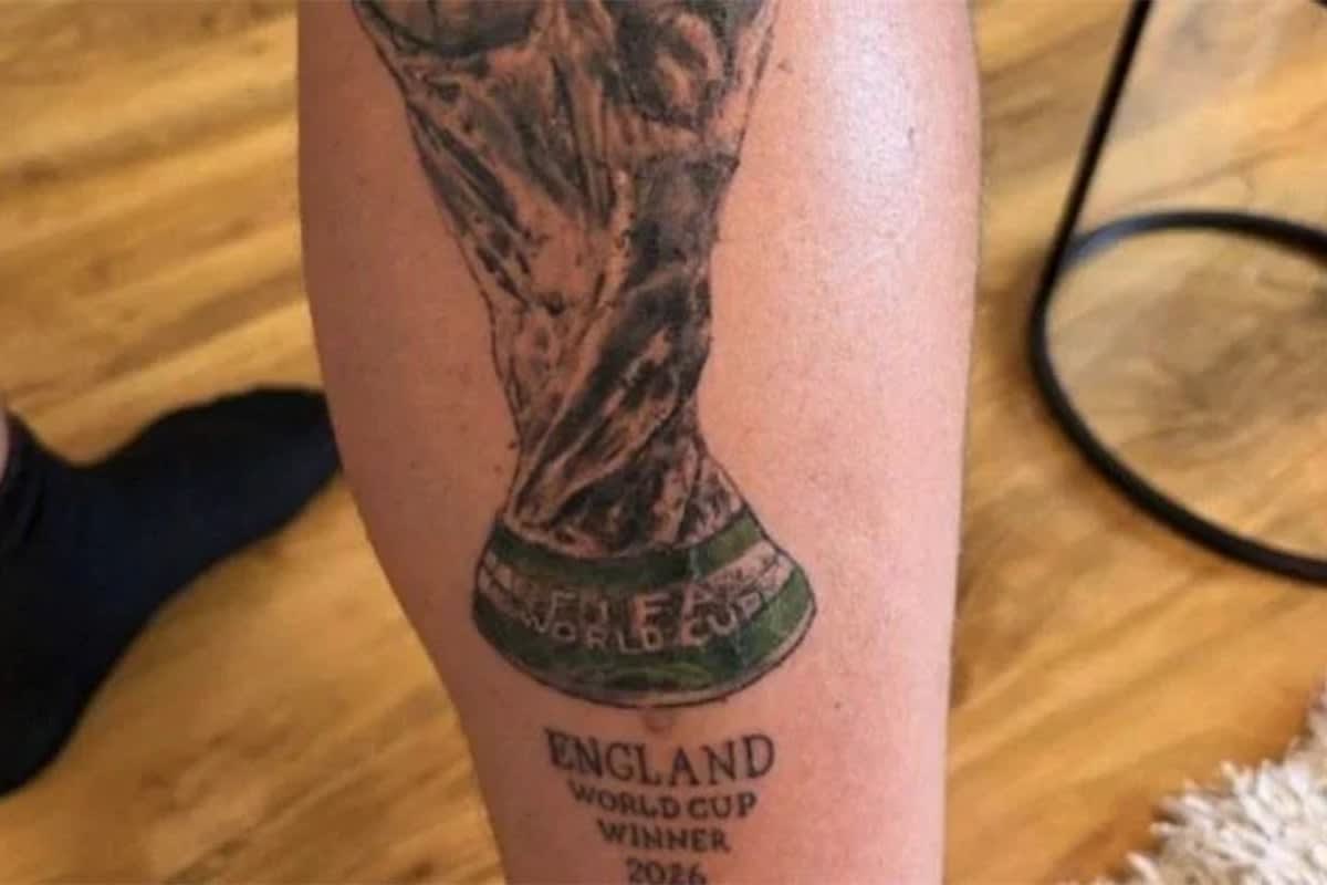 Man showing leg tattoo reading "England World Cup Winner 2026 Just joking" at tattoo studio