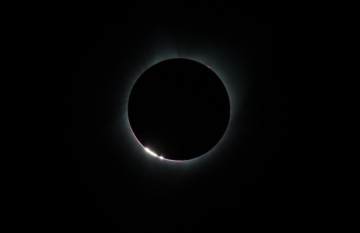 Moon completely blocking the sun during total solar eclipse showing corona