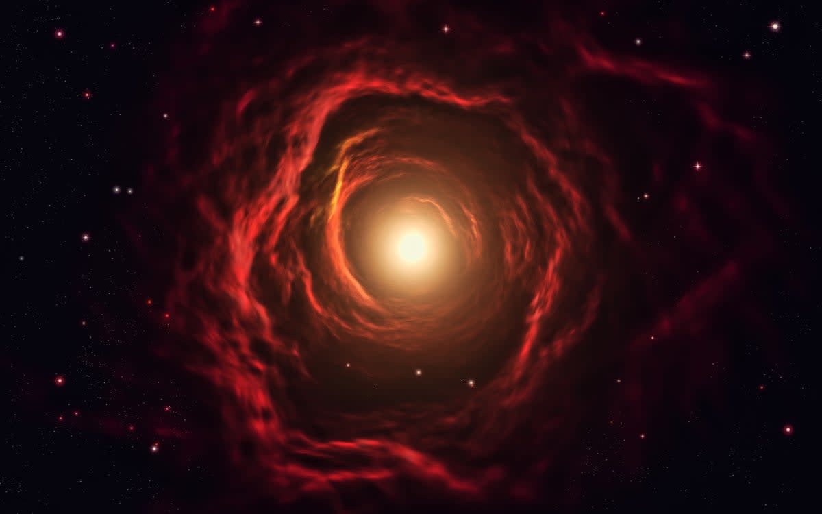 Artist rendering of crimson red galaxy glowing against dark space with stars