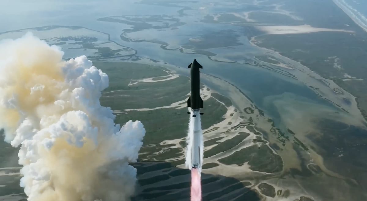 SpaceX Starship rocket launching into twilight sky with bright engine flames visible below