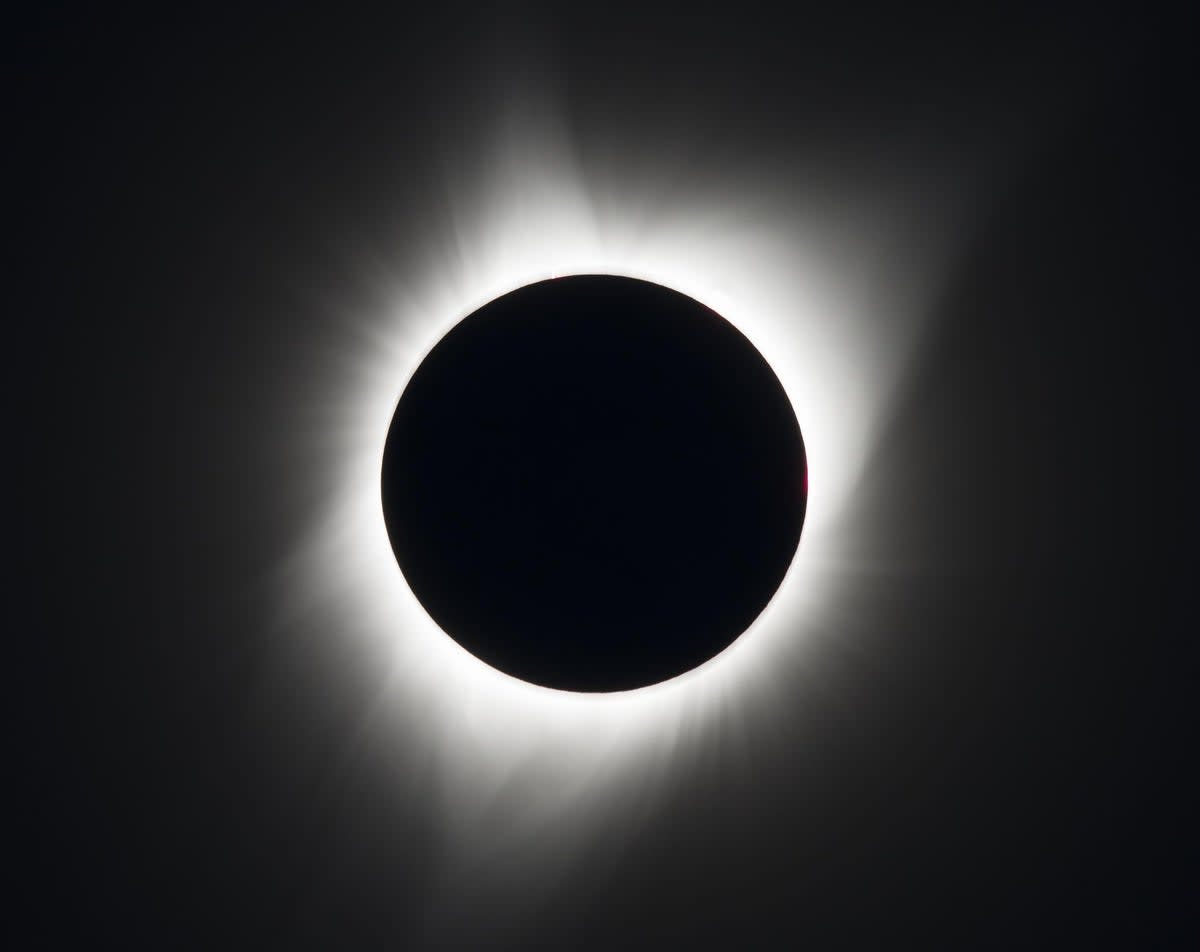 View from Orion spacecraft showing moon blocking sun during total solar eclipse above lunar surface