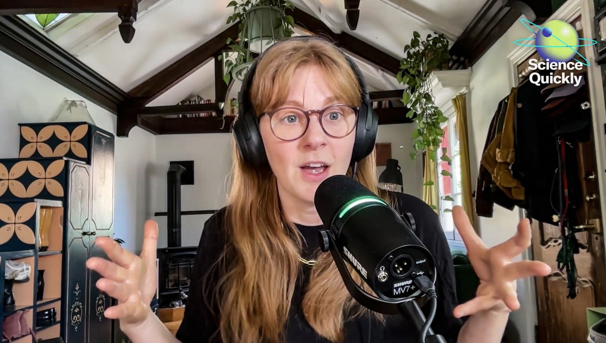 Swedish inventor Simone Giertz smiling while working on creative engineering projects in her workshop