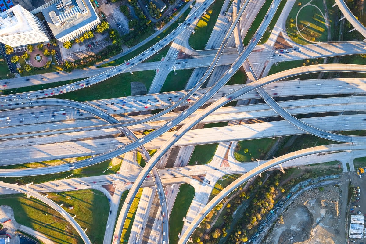 Aerial view of multi-level highway bridge interchange showing complex infrastructure network requiring monitoring