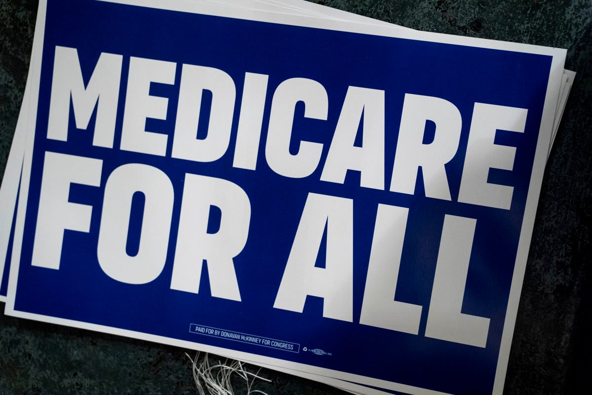 Medicare for All rally sign held at political event supporting universal healthcare coverage