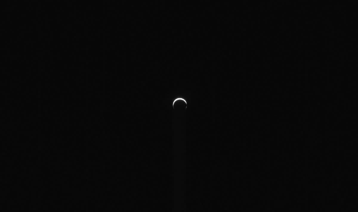 Crescent Mars photographed by NASA's Psyche spacecraft showing bright dusty atmosphere with darker polar region