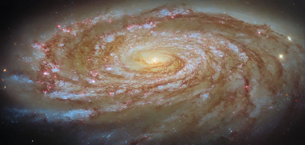 Spiral galaxy Messier 88 with bright center and colorful spiral arms against deep space