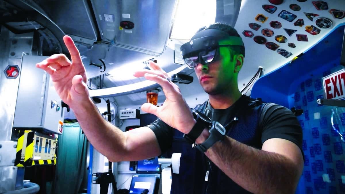 Research volunteer wearing augmented reality goggles during simulated space mission training at NASA facility