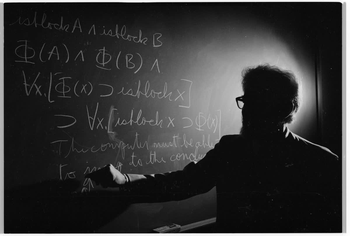 Researcher working at blackboard with mathematical equations representing AI-assisted scientific discovery breakthroughs