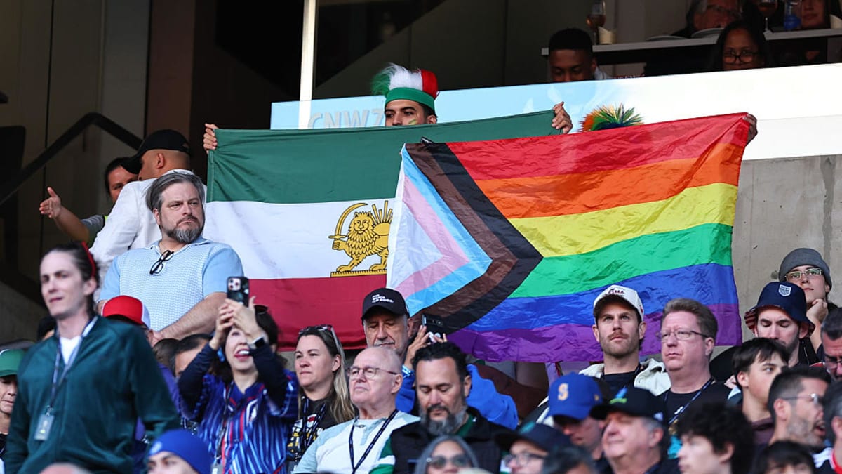 Diverse soccer fans celebrating together outside Seattle Stadium during World Cup Pride Match