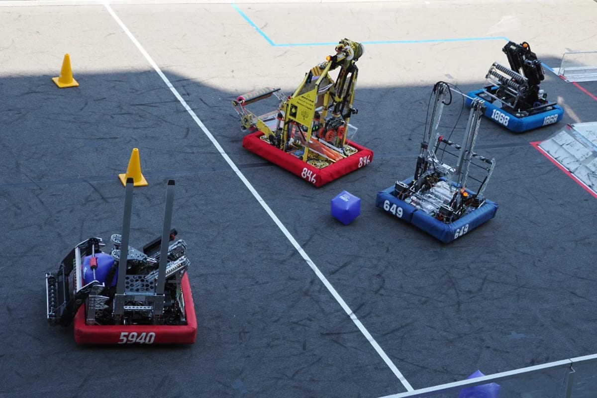 Students working on robotics project at competition table in Morocco university library