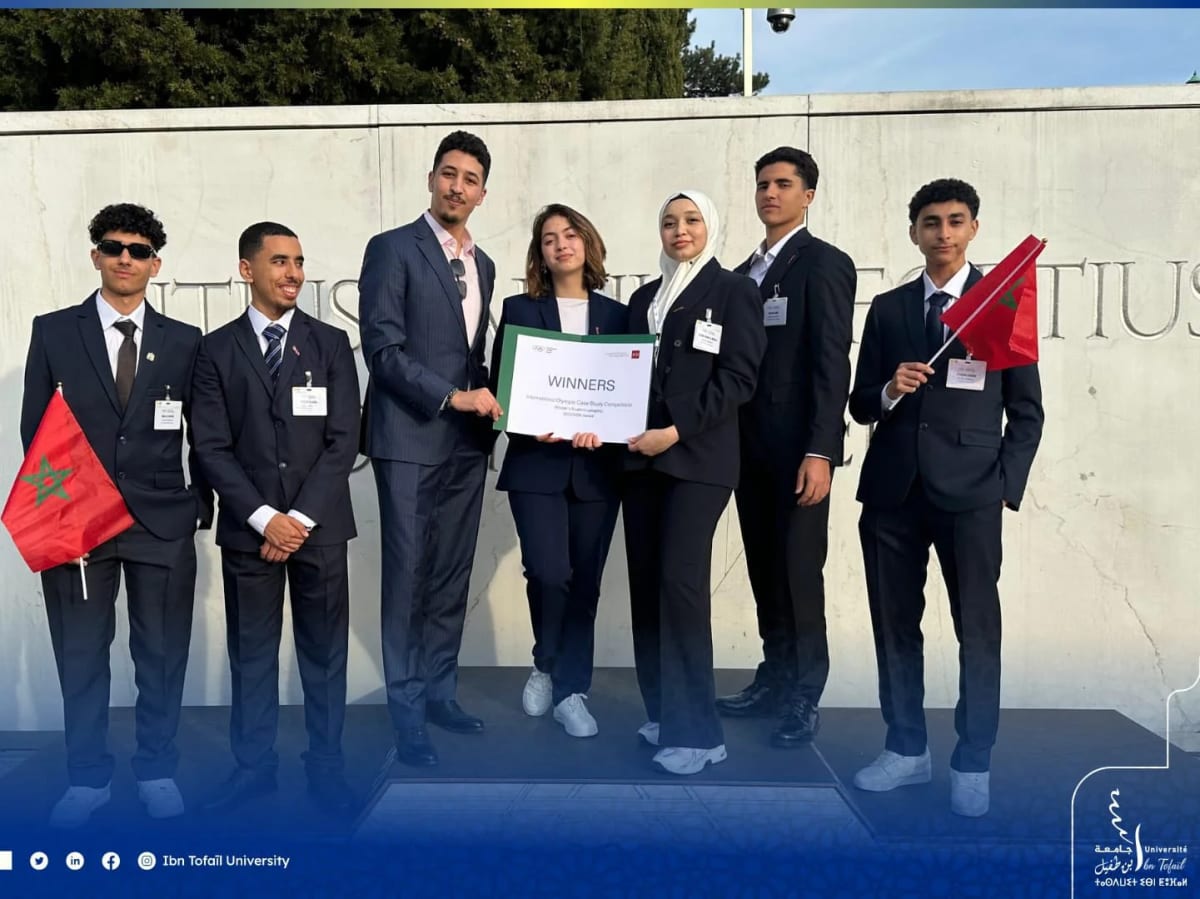 Moroccan university students celebrating victory at Olympic competition in Switzerland with trophy