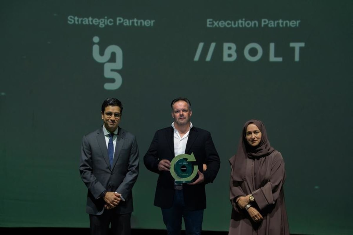 Entrepreneur presenting desert greening technology with biochar soil samples at Dubai innovation competition
