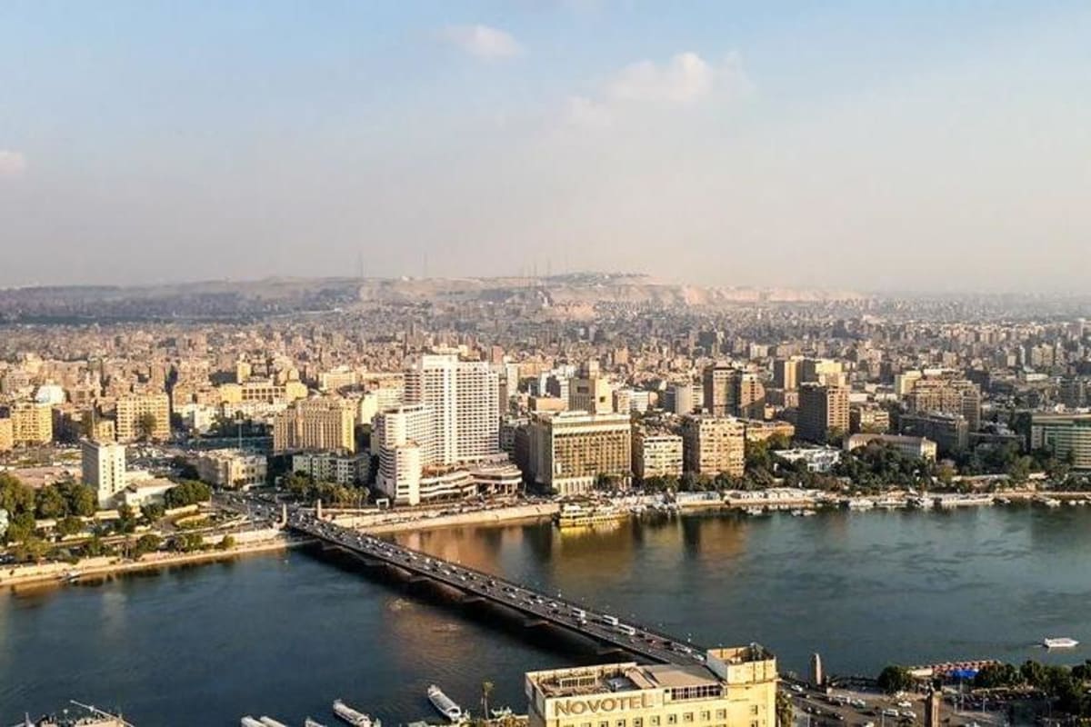 Egyptian doctor using digital pathology system to review patient scans on modern computer screen