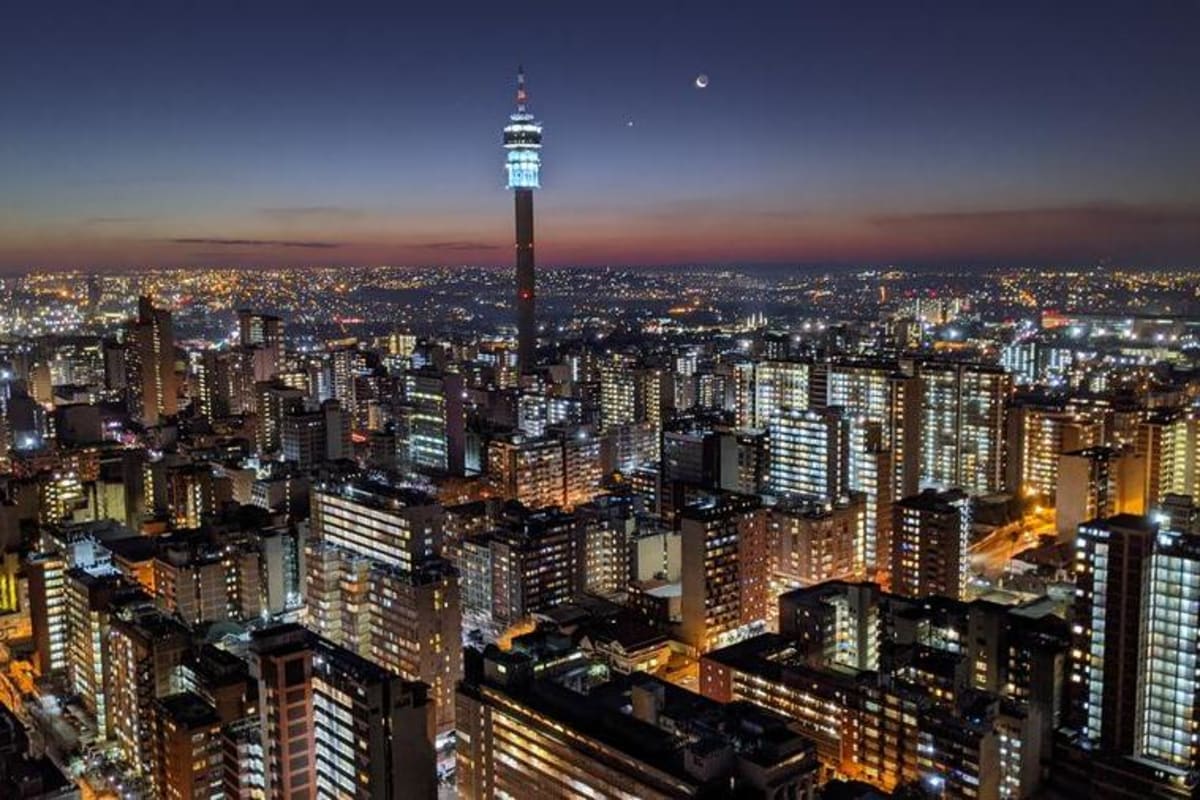 South African entrepreneur working on laptop in modern startup office space