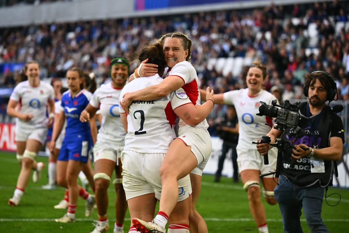 England women's rugby players celebrating a try scored against France during championship match