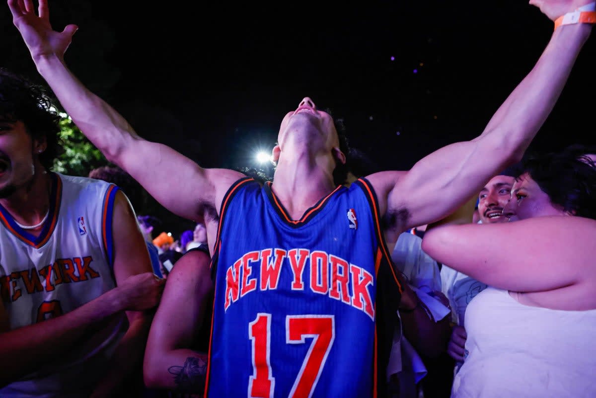 ** Knicks fans celebrating championship victory in Central Park after historic NBA Finals win