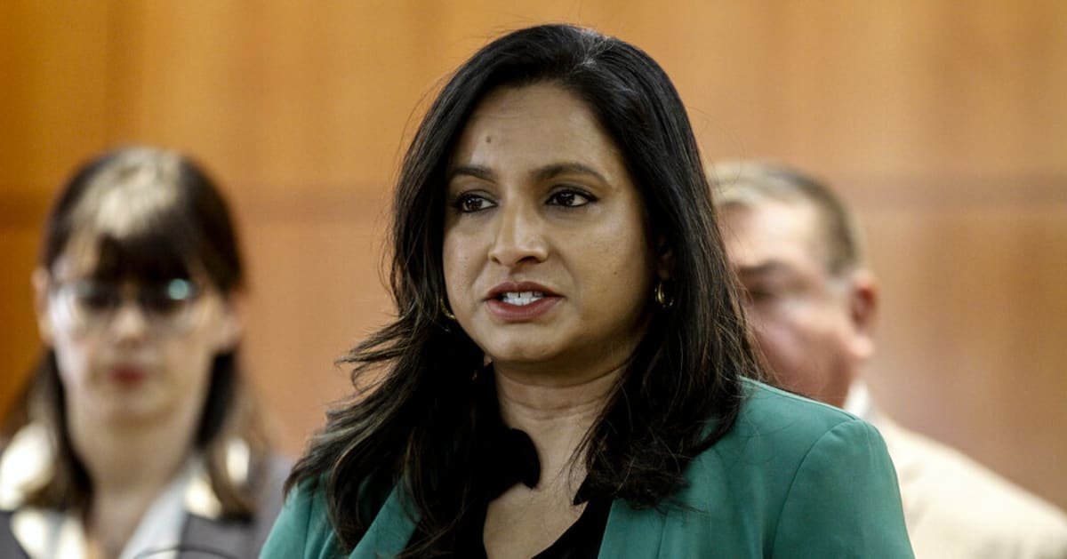 Happy family reviewing health insurance documents together at kitchen table in New Mexico home