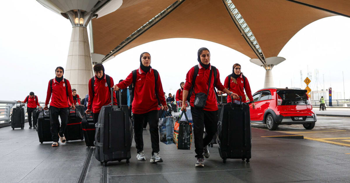 Iranian women's national soccer team players standing together during international tournament match