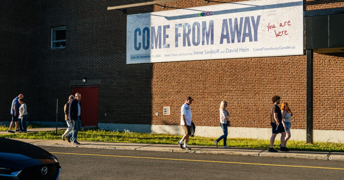 Theater stage with audience members watching Come From Away musical performance in Gander Newfoundland