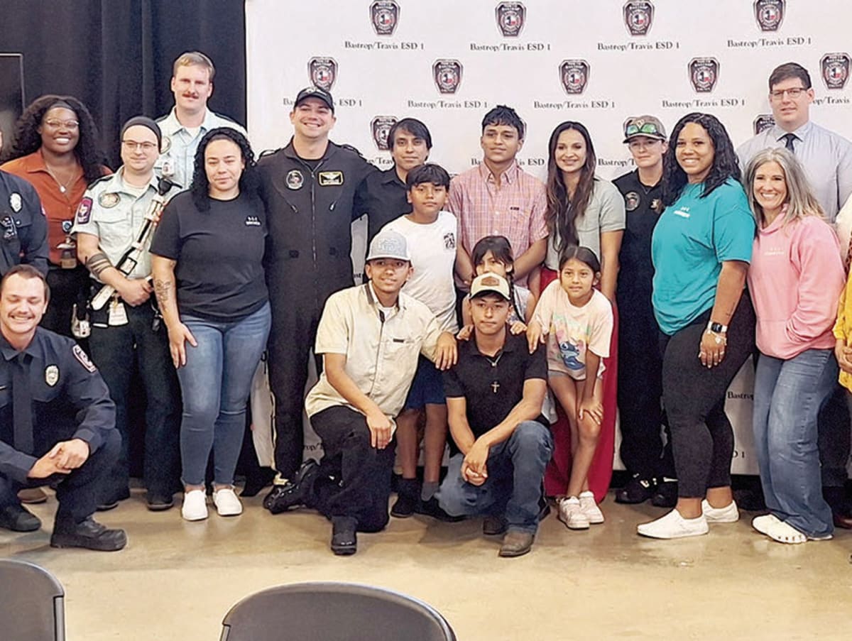 Teen Juan Tomelloso Chavez stands with his parents and first responders at reunion ceremony