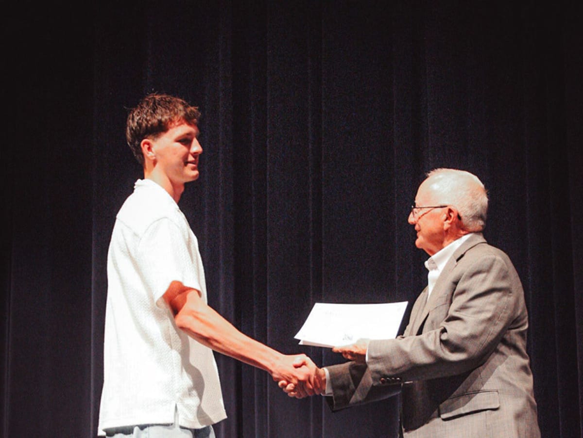 Five Newcastle High School scholarship recipients and presenters gathered at school auditorium ceremony