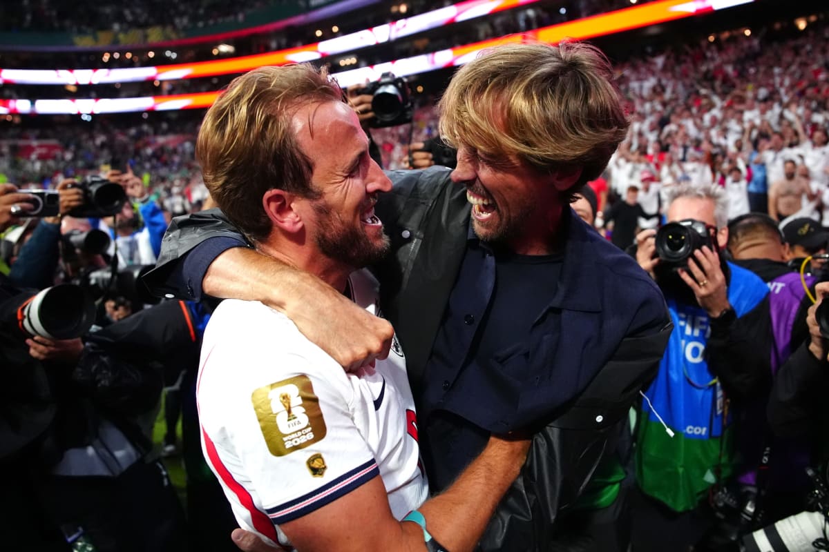 Harry Kane embracing Peter Crouch while presenting him with England legacy cap