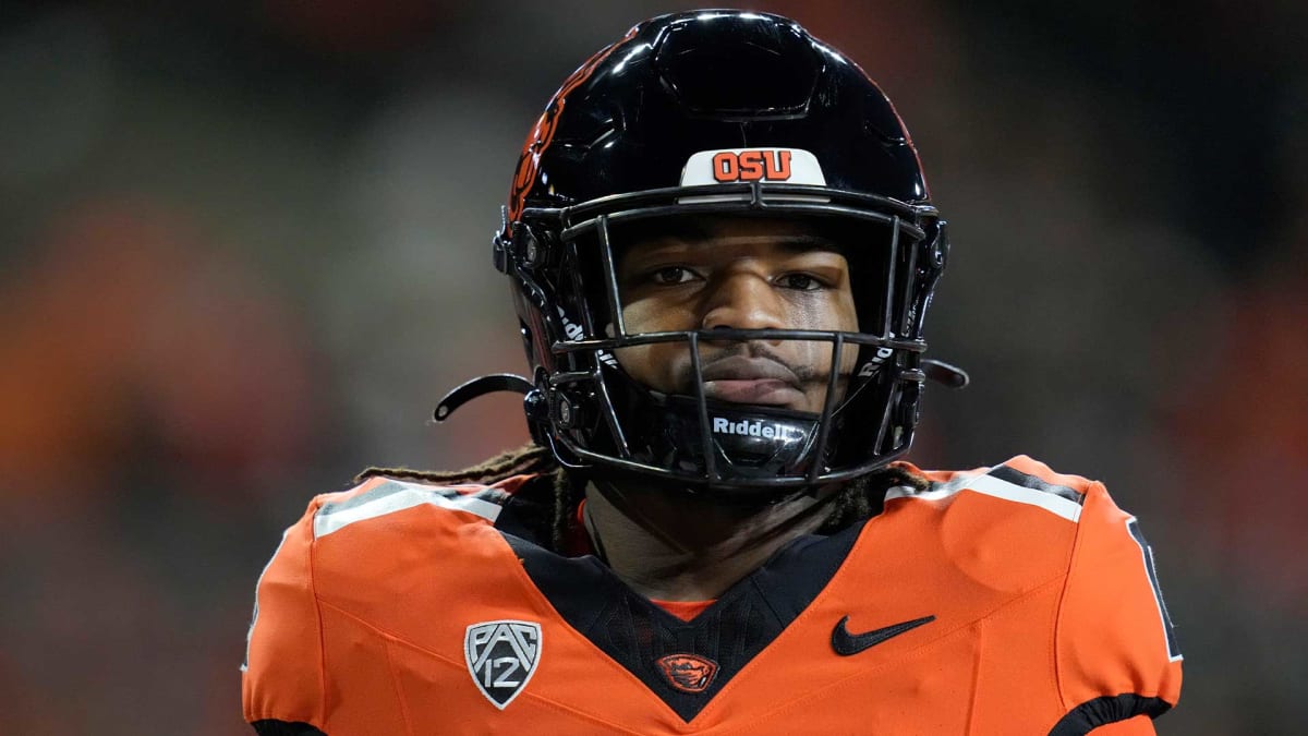 Anthony Hankerson in Oregon State Beavers football uniform running with the ball during game