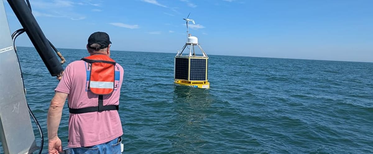 Solar-powered PowerBuoy floating research platform deployed off New Jersey coast with instruments