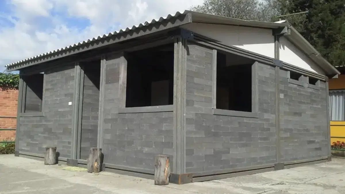 Colorful modular plastic blocks assembled into affordable housing structure in Colombia