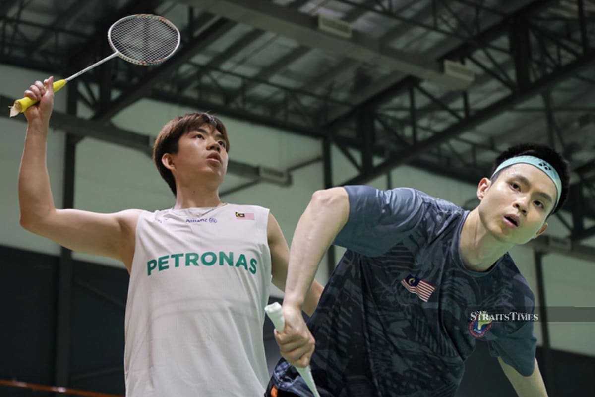 Malaysian badminton doubles team Man Wei Chong and Soh Wooi Yik celebrating on court