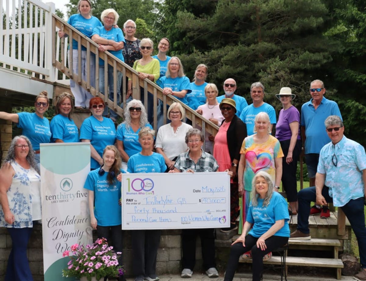Group photo of 100 Women Who Care Grey Bruce members presenting donation to TenThirtyFive charity representatives