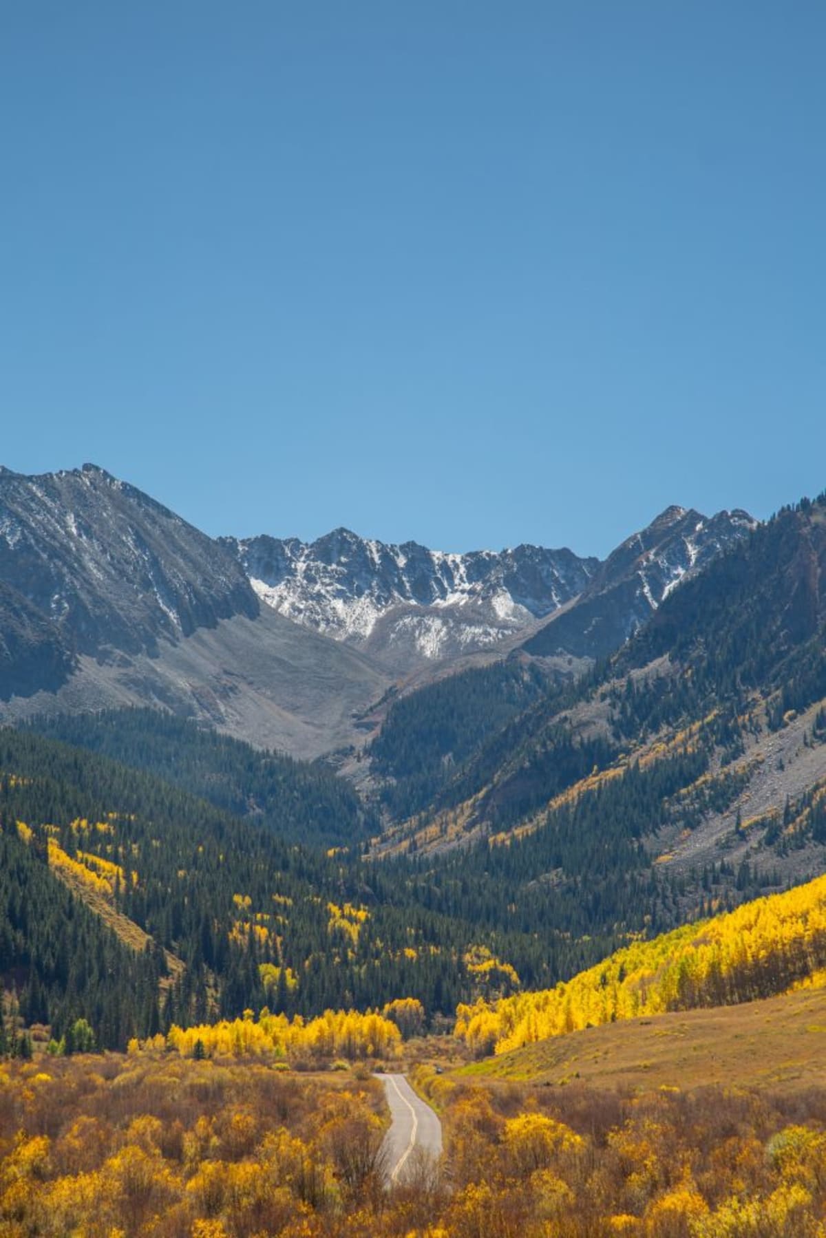 Mountain rescue volunteers skiing through snowy backcountry terrain in Colorado's Elk Range mountains