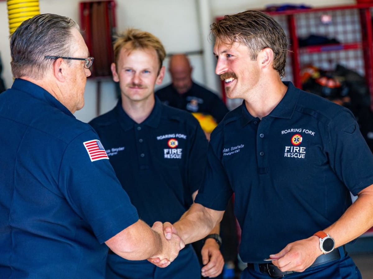 Four new firefighters stand with their training lieutenant after graduation ceremony in Basalt