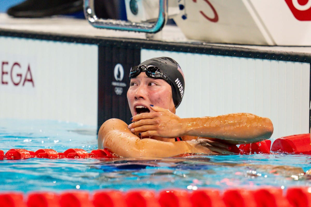 Olympic swimmer Torri Huske celebrating with gold medal in Paris pool