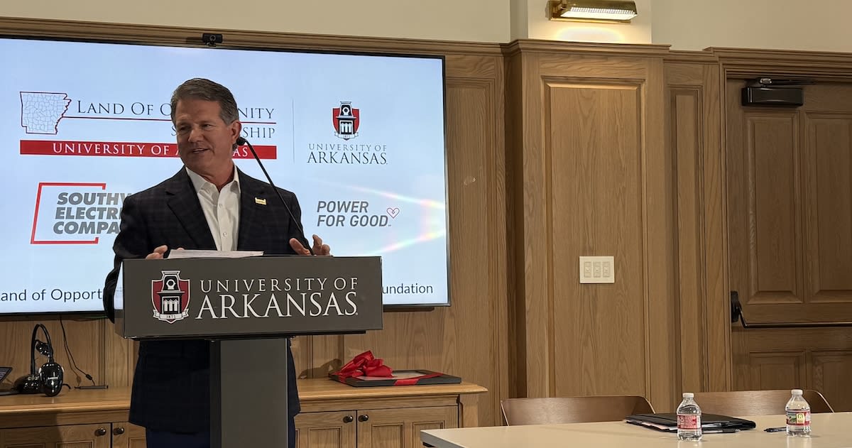 University of Arkansas Chancellor and SWEPCO President shake hands at scholarship partnership announcement ceremony