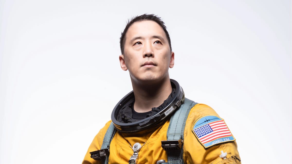 Navy Lt. Cmdr. Jonny Kim in NASA flight suit smiling at camera in official portrait
