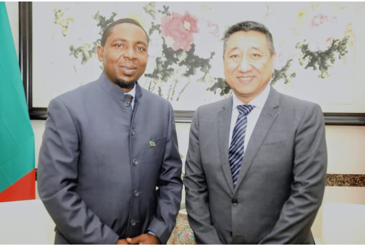Zambian and Chinese officials shake hands at technology partnership meeting in Lusaka