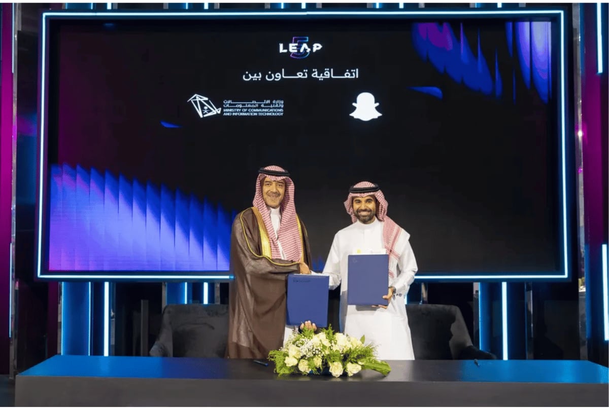 Young Saudi professionals learning digital marketing and augmented reality skills on laptops and tablets