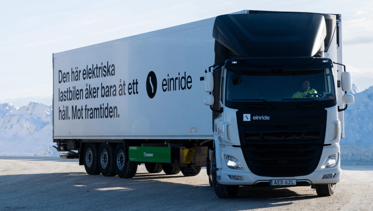Modern electric semi-truck charging at commercial charging station with software dashboard display