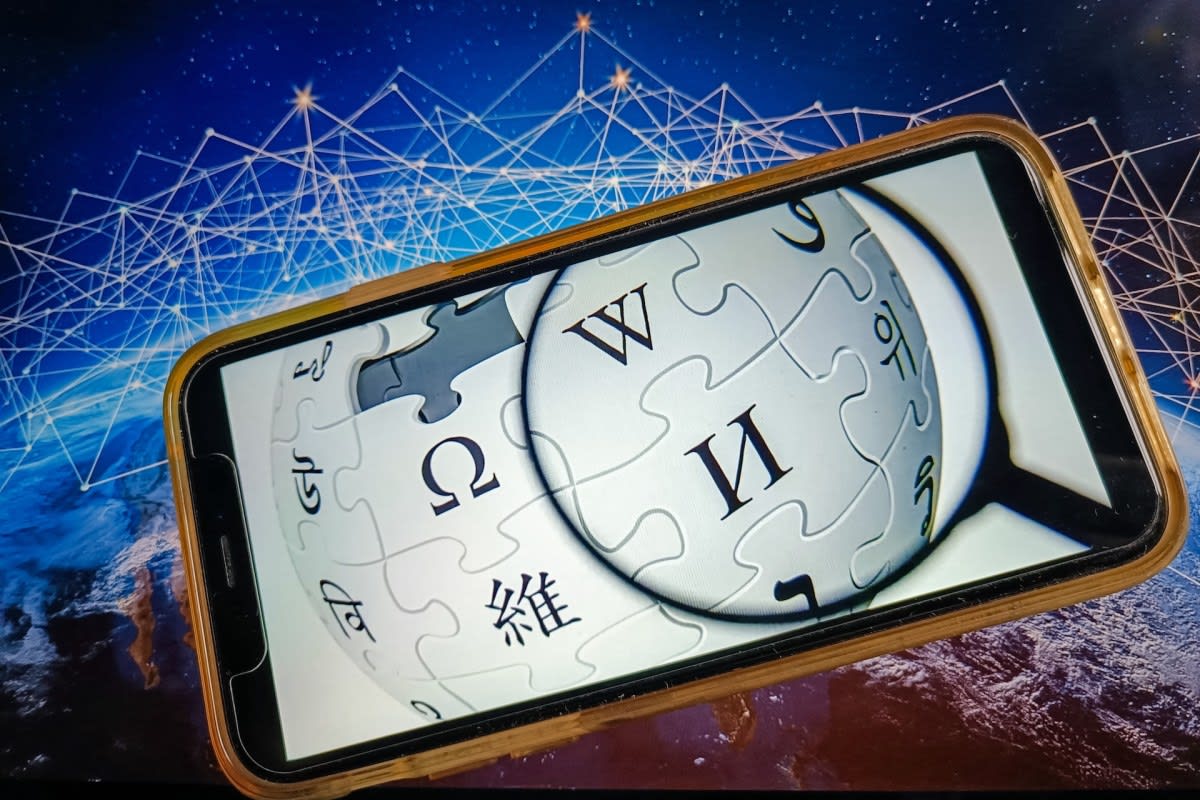 Wikipedia logo on computer screen representing community decision to ban AI-written articles