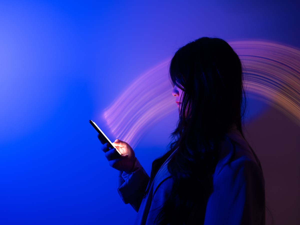 Smartphone screen showing colorful educational app icons against bright, hopeful background lighting